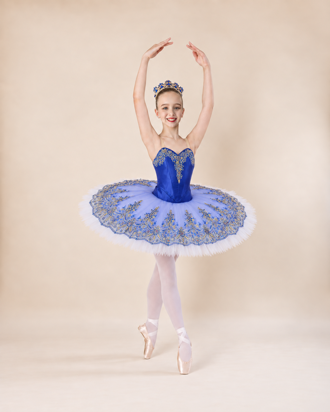 Dancer wearing a royal blue and gold classical tutu with matching tiara